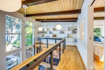 Upper loft area. Note the wall of shelves for display or library storage.