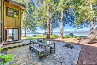 Just look at that beautiful stone patio with a fire pit and pretty views.