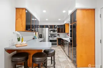 Kitchen with bar eating space, tile floors and lots of storage!