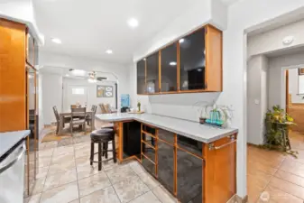 Kitchen opens to hallway that leads to the main floor bedrooms, bathroom and basement access.
