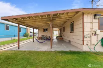 Covered back patio with lots of space for BBQ, patio furniture and storage.