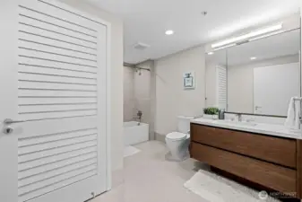 Designer tile bath surrounds and flooring.