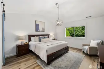 Vaulted ceilings make this big primary feel even more spacious