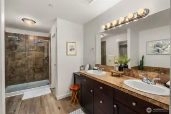 Primary bath with dual sinks, shower, tub and walk-in closet.
