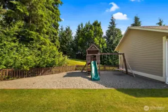 Playground in the fenced backyard.