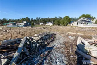 Natural beach access path leading back toward nearby residences, highlighting the connection between community living and waterfront access.