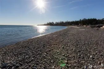Sun-filled waterfront view showcasing the tranquil marine environment and coastal lifestyle available in Cape San Juan on San Juan Island.