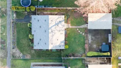 Aerial view showcasing generous lot size and full fencing.