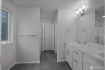 Primary bath with dual vanities, modern fixtures, and ample storage.