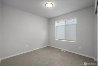 BR 4 - Comfortable guest room with ample wall space and modern trim.