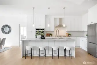 Large kitchen, with an oversized island, fits 4 at the bar, under slab cabinets for extra storage. Full ceiling-height cabinets.