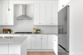 Beautiful upgraded gray-stone quartz counters. Herringbone tile backsplash. Soft-close cabinets.