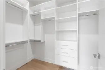 Huge walk-in closet with complete custom built-in shelves, hangers, and drawers!