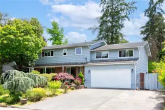 Front - 2 story home with beautiful trees & flowers give warm welcome