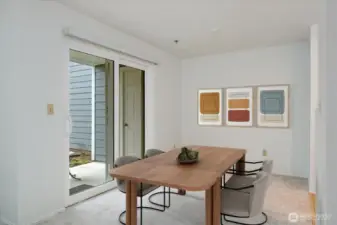 Dining area next to kitchen and outdoor patio.  Virtually staged.