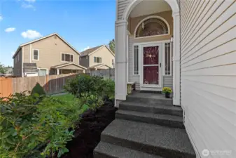 Lovely landscaping greets you as you enter the front door
