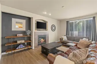 Open concept living room with cozy fireplace