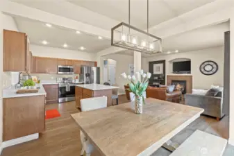 Dining area is tucked to the side but still part of the action