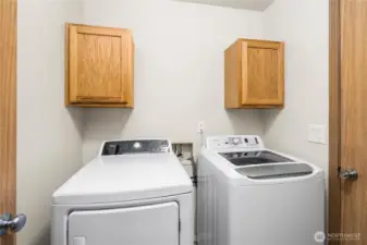 Washer and Dryer in small room adjacent to garage.