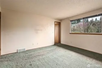 Primary bedroom.  Window looks out the the back yard.