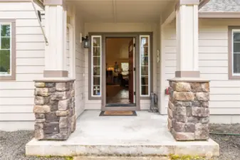 A lovely, covered porch with stone accent greets your guests!
