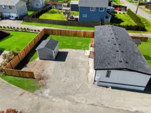 Alley access leads to parking space and back yard with outbuilding.