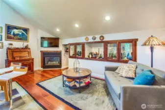 Living room in guest studio with built-ins and propane fireplace.