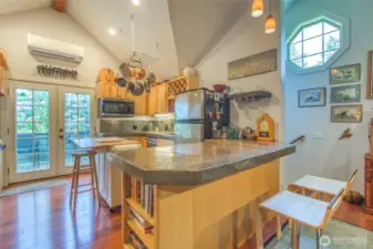 Plenty of natural light shines on this open floor plan in the guest studio. Vaulted ceilings throughout, french doors open up to private deck (new). Well appointed kitchen welcomes imagination and entertaining.