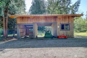 Handy machine shed with side workroom.
