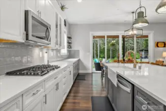 Entertainers dream kitchen features 5 burner gas stove, double oven, side by side fridge. All stainless steel appliances.