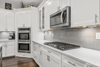 Double oven, 5 burner gas stove, built in microwave. All soft close cabinets with pull out shelving.