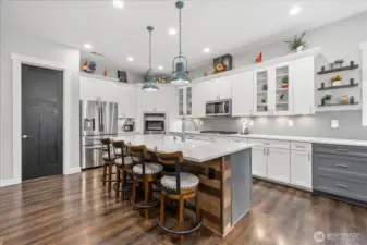 Open concept kitchen featuring walk in pantry and coffee bar.  All quartz countertops and thoughtful touches.