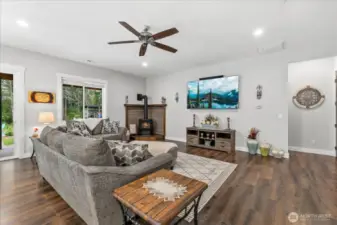 Extra large living area with freestanding gas stove to keep you cozy in the winter. Decorative barnwood surround and in floor electrical outlets.