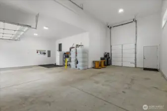 Massive garage features 2 car bay PLUS RV bay with 16' high garage door with 8' wide single garage door leading to back yard.  Room for all your toys with room to navigate through garage or on side.