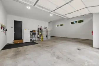 View from 2 car bay. Water heater and fire suppression water tank located here.  Right side is the RV bay with pull through access open to back yard. 200 amp electrical service to the home with generator hook up in the shed out back.