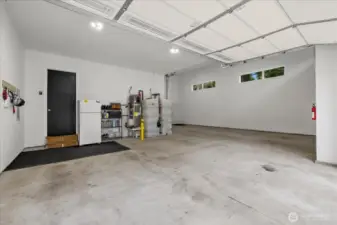 View from 2 car bay. Water heater and fire suppression water tank located here.  Right side is the RV bay with pull through access open to back yard. 200 amp electrical service to the home with generator hook up in the shed out back.