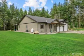 Side yard.  Very low maintenance, but beautiful! Propane tank located on this side (leased)