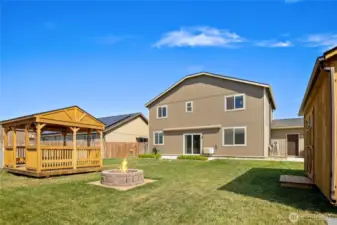 Well designed back yard with a large patio with awning, a gazebo, firepit and storage shed/workshop.  Notice there is a man door into the garage from the back patio!
