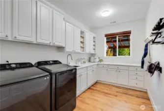 A laundry room of your dreams! All new countertops and backsplash. Lots of storage and a 2023 washer / dryer set!