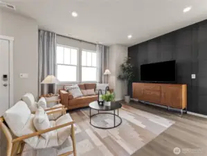 Light-filled great room showcases designer accent wall, recessed lighting and oversized windows for relaxed gatherings. Pictures are for representational purposes only, colors and features may vary.