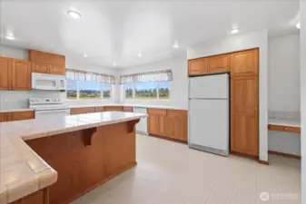 Kitchen with bar and desk space.
