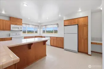 Kitchen with bar and desk space.
