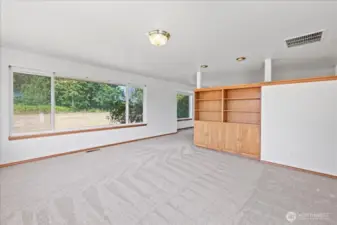 Family room with bookshelf and storage.