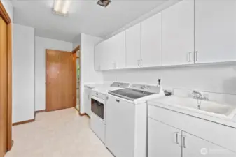 Spacious laundry room/mudroom with plenty of storage.