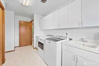 Spacious laundry room/mudroom with plenty of storage.