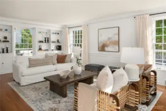 Light-filled living room offers plenty of seating and a fireplace.