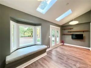 French doors, skylights and a bay window letting the light cascade into this great space... This was used as an office and with a double outside entry door it is very versatile.