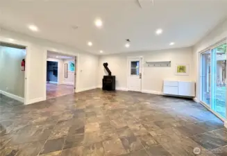 Lower level is a large space and is extremely versatile. Door to the back yard and garage.