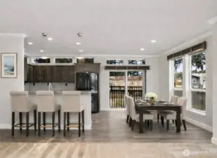 Open dining and kitchen area offers ample space for meals, gatherings, and casual bar seating.  (photo virtually staged)