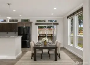 Dining area is filled with natural light and offers an inviting space for everyday meals or hosting guests. (photo virtually staged)